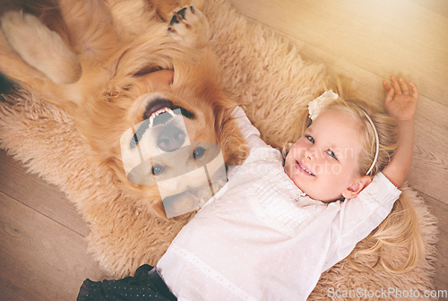 Image of Girl, dog and portrait together on floor in living room or golden retriever, kid and smiling with pet above lounge carpet. Young child, Labrador and happiness or family home, pets and top view