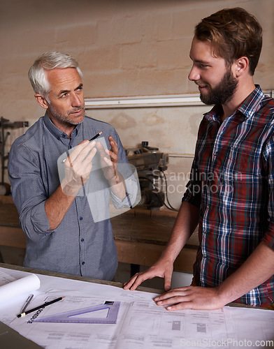 Image of Architecture team, working on blueprint in workshop, designer and engineering collaboration. Senior mentor, male training architect and work together on remodeling project with floor plan paperwork