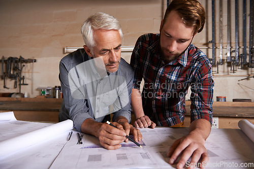 Image of Architect team, working on blueprint in workshop and designer for engineering collaboration. Senior in architecture with male trainee, work on remodeling project with floor plan paperwork and drawing