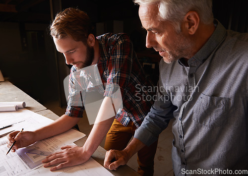 Image of Architecture team, blueprint design in workshop and designer for engineering collaboration. Male architect in meeting, planning and working on remodeling project with floor plan paperwork and drawing