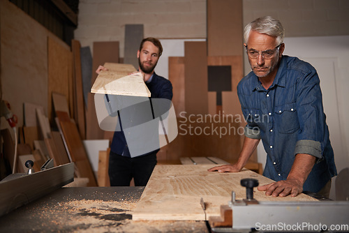 Image of Carpentry, carpenter and men in workshop work on design project with team, vocation and creative DIY skill. Teamwork, collaboration and male employee saw wood with father and son working together