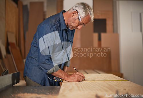 Image of Carpenter in workshop, measurement and man with pencil, measuring tape and designer furniture manufacturing. Creativity, small business and carpentry, professional planning sustainable wood project.