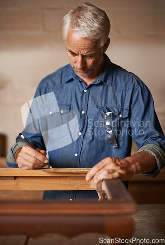 Image of Carpentry, furniture design and man with pencil, measurement and designer wood manufacturing workshop. Creativity, small business and professional carpenter planning sustainable restoration project.