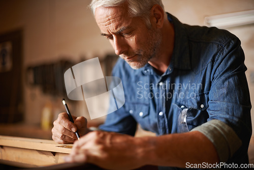 Image of Carpentry, furniture manufacturing and man with pencil, focus and wood design workshop at small business. Creativity, thinking and professional, senior carpenter working on wooden designer project.