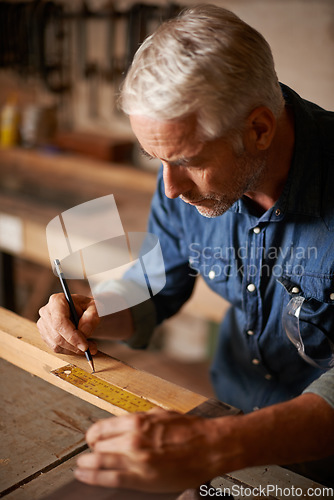 Image of Carpentry, woodwork and man with pencil, ruler and designer furniture manufacturing workshop. Creativity, small business and focus, professional carpenter planning sustainable wood project design.