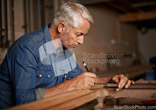 Image of Carpentry, focus and man with pencil, table and creative work at furniture manufacturing workshop. Creativity, small business and professional carpenter working on sustainable wood project design.