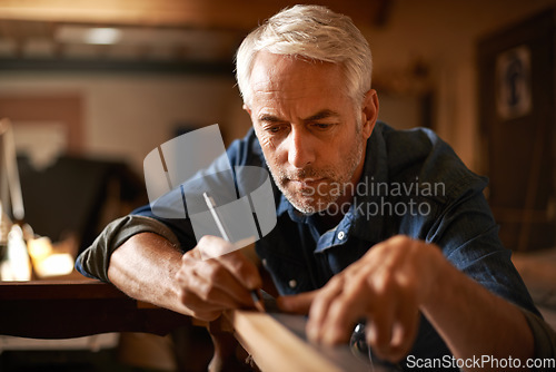 Image of Furniture restoration, pencil and carpenter man in antique table manufacturing workshop with focus. Concentration, small business and expert carpentry, woodwork for sustainable wood project design.