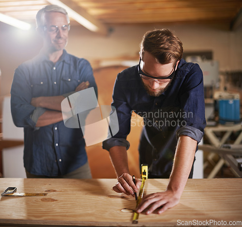 Image of Mentor carpenter, apprentice and wood measurement at designer furniture manufacturing workshop. Proud mentorship, carpentry and men at sustainable business, teaching and learning with design project.