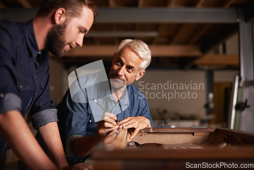 Image of Carpentry workshop, learning and man with apprentice teaching expert tips and help for furniture manufacturing. Mentorship, professional carpenter and student in training working on wood work project