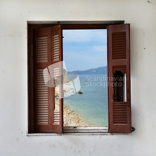 Image of beach landscape through broken window