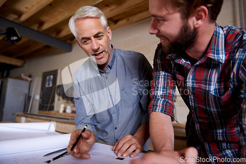 Image of Architect team, blueprint design in workshop and designer for engineering collaboration. Senior in architecture with male trainee, work on remodeling project with floor plan paperwork and drawing