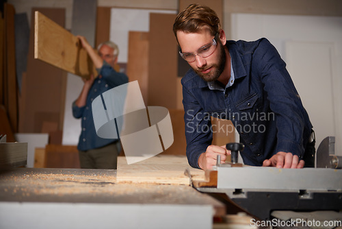 Image of Carpentry team, carpenter and men work in workshop on design project with vocation and creative skill. Collaboration, teamwork and male cutting wood with power tools, father and son working together