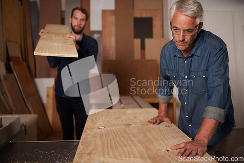 Image of Carpentry, carpenter and men in team in workshop, design project with vocation and creative DIY skill. Teamwork, collaboration and male employee with wood beam, father and son working together