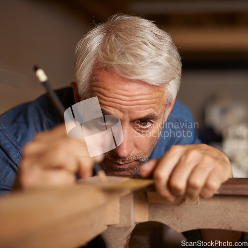 Image of Focus, measurement and carpenter with pencil, furniture and designer table manufacturing workshop. Creativity, small business and professional carpentry, man working on sustainable diy wood project.