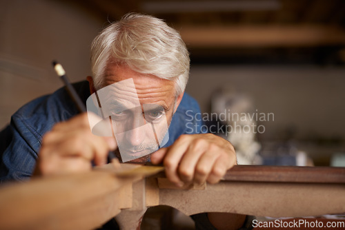 Image of Focus, furniture manufacturing and carpenter with pencil, table and antique restoration workshop. Creativity, small business and professional carpentry measurement for sustainable wood project design