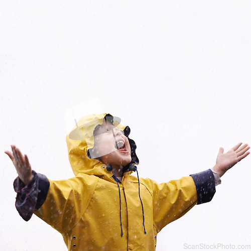 Image of Girl child, rain and playing with space for mockup with shouting, happiness or winter fashion. Female kid, raincoat or playful with water, open hands or screaming on adventure with freedom in mock up