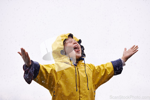 Image of Girl outdoor, rain and playing in space for mockup with tongue, happiness or winter fashion. Female child, raincoat or play with water, open palm or excited face on adventure with freedom in mock up