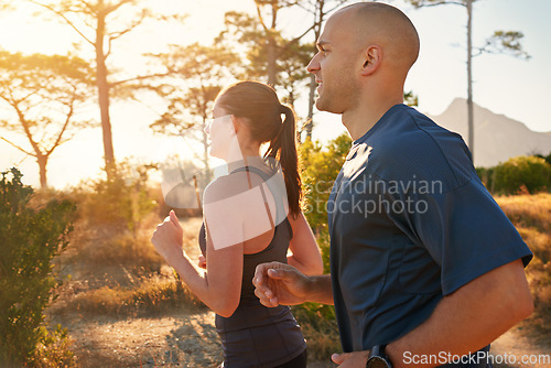 Image of Sunrise, forest and friends running as exercise or morning workout for health and wellness together. Sport, man and woman runner on trail run with athlete as training in nature for sports or energy