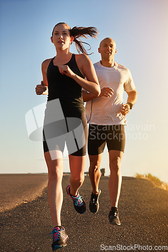 Image of Sunrise, marathon and friends running as workout or morning exercise for health and wellness together. Sport, man and woman runner run with athlete as training, sports or energy on a road