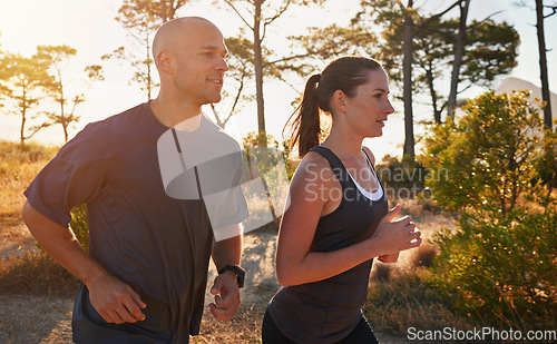 Image of Sunrise, forest and couple on trail run as workout or morning exercise for health and wellness together. Sport, man and woman runner run with athlete as training on a mountain for sports or energy