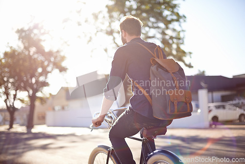 Image of Bicycle, transport and man cycling in road with lens flare for exercise, commute and riding in morning. Travel, city and male cyclist on bike for eco friendly traveling, carbon neutral and journey