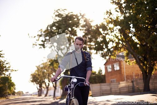 Image of Bicycle, transport and man in road walking with lens flare for exercise, commute and cycling in morning. Travel, city and male cyclist with bike for eco friendly traveling, carbon neutral and journey