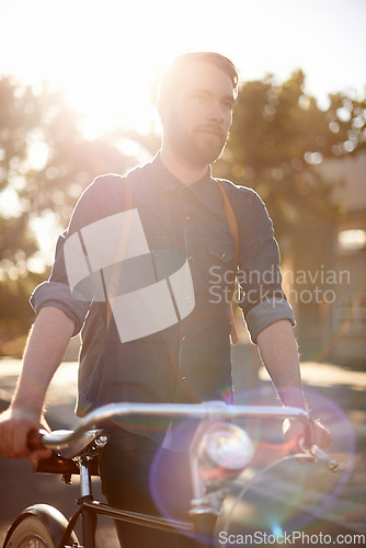 Image of Walking, transport and man in road with bicycle for exercise, commute and cycling in morning. Travel, lens flare and male cyclist with bike for eco friendly traveling, carbon footprint and journey