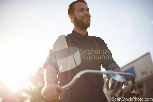 Image of Travel, bicycle and happy man in road with lens flare for exercise, commute and cycling in morning. Transport, city and male cyclist on bike for eco friendly, carbon footprint traveling and journey