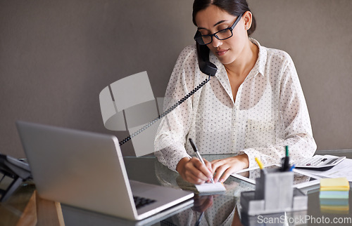 Image of Telephone, laptop and woman writing while on a call in office doing research on internet. Technology, landline and professional female employee working on corporate project with computer in workplace