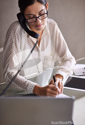 Image of Telephone, write and female secretary on a call doing research on internet with laptop. Technology, landline and professional corporate receptionist working on project with computer in the workplace.