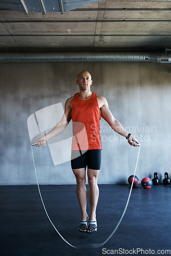 Image of Keep it going. Fitness, jump rope and portrait of man doing gym training, cardio endurance challenge or exercise performance. Skipping, active lifestyle and male sports person doing jumping workout.