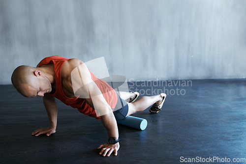 Image of Gym training, foam roller and man doing floor push up for exercise, health performance and muscle building workout. Fitness club mock up, stretching and strong person focus on strength challenge