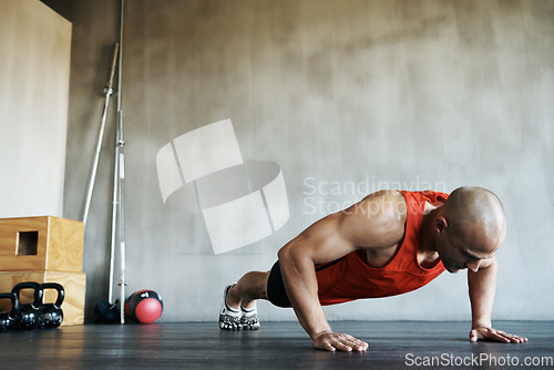 Image of Workout, muscular and man doing gym studio push up for exercise, health performance and sports training for muscle building. Bodybuilding routine, determination or strong person doing floor pushup