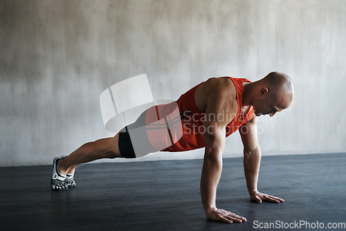 Image of Workout, muscular and man doing push up for exercise, health performance and sports training for muscle building. Bodybuilding mockup, healthy gym body and strong person doing studio floor pushup