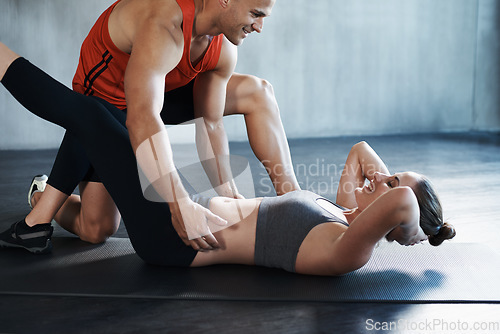 Image of Gym, people and personal trainer coaching woman with floor sit up, fitness performance or teamwork core exercise. Health club workout, training partner and team coach helping person with challenge