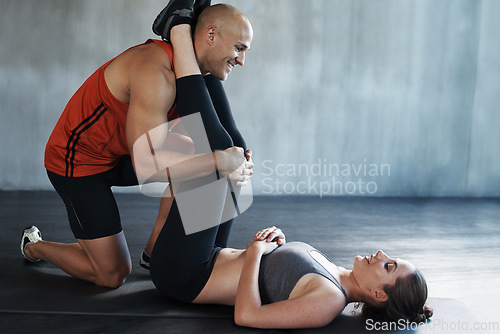 Image of Gym floor, team and coach coaching happy woman with workout, fitness routine or core collaboration exercise. Training, partnership and personal trainer, man or person helping girl with challenge