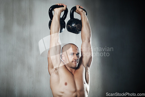 Image of Fitness, man and weightlifting with kettlebell for workout, arm exercise or training at the gym. Serious muscular man lifting weight for strong exercising, power or strength in muscle bodybuilding