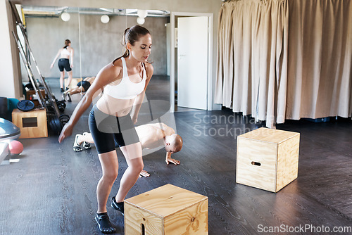Image of Fitness, exercise and woman with jump box for training, workout and intense cardio at a gym. Health, jumping and people at a sports center for wellness, performance and endurance challenge together
