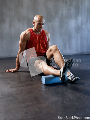 Image of Fitness, foam roller or man stretching legs on floor for gym workout, healthy lifestyle or athlete pain relief. Health wellness massage, muscle warm up or relax person start exercise training routine