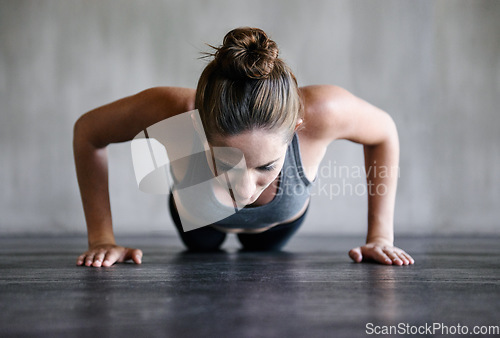 Image of Training, push up and woman on a floor for fitness, cardio and endurance at gym. Plank, exercise and female athlete at a health center for core, strength and ground workout with determined mindset
