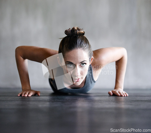 Image of Pushup, fitness and woman on a floor for training, cardio and endurance at gym. Push up, exercise and female athlete at a health center for core, strength and ground workout with determined mindset