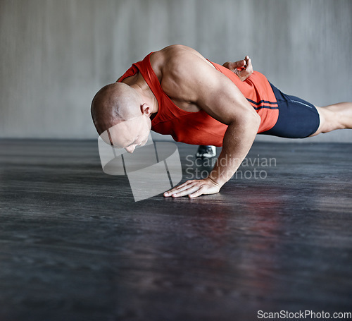 Image of Training, muscle strength and strong man doing push up for studio floor performance, gym routine or health club commitment. One arm pushup, motivation and male person workout, exercising or fitness