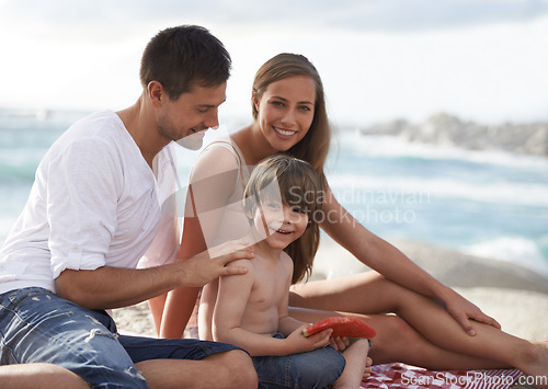 Image of Family, child and watermelon portrait at beach on travel holiday in summer with a smile for fun. A man, woman and kid eating fruit on a picnic while together on vacation at sea for happiness and care