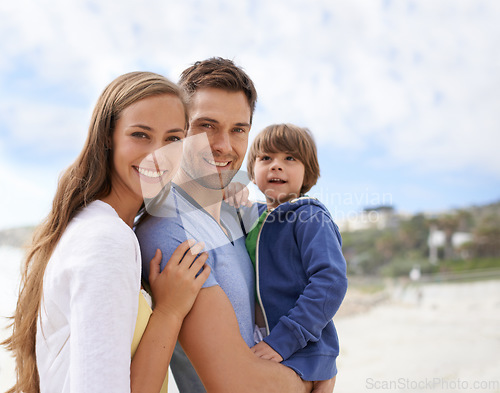 Image of Family, child and portrait outdoor at beach for travel, adventure or holiday in summer with a smile. A man, woman and kid or son together on vacation at sea with a blue sky, parents and happiness