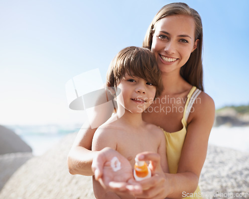 Image of Family, child or portrait at beach with sunscreen lotion on body for sun protection on travel or holiday in summer. A woman or mom and kid together on vacation at sea with smile, cream and happiness