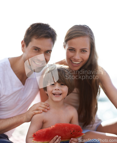 Image of Family, watermelon and summer portrait at beach on travel holiday with a smile and fun. Man, woman and kid eating fruit and together on vacation at sea with love, care and happiness outdoor in nature