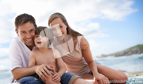 Image of Happy family, child and portrait at beach for travel holiday in summer with a smile and fun. A man, woman and kid or son together on vacation, adventure or picnic at sea with a blue sky and happiness