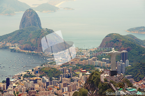 Image of Brazil, monument and Christ the Redeemer in city on hill for tourism, sightseeing and travel destination. Traveling, Rio de Janeiro and aerial view of statue, sculpture and landmark on mountain