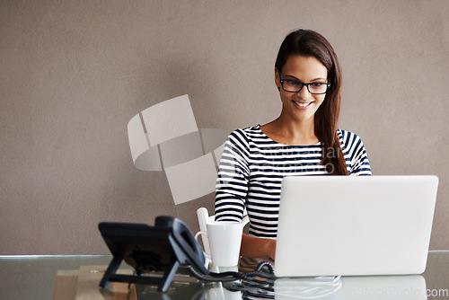 Image of Laptop, mockup and business woman in office for planning, management and checking email on wall background. Happy, inspired and female manager online for project, proposal or creative idea research