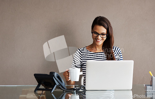 Image of Laptop, tea and happy business woman in office for planning, management and checking email on wall background. Coffee, smile and female manager online for project, proposal or creative idea research